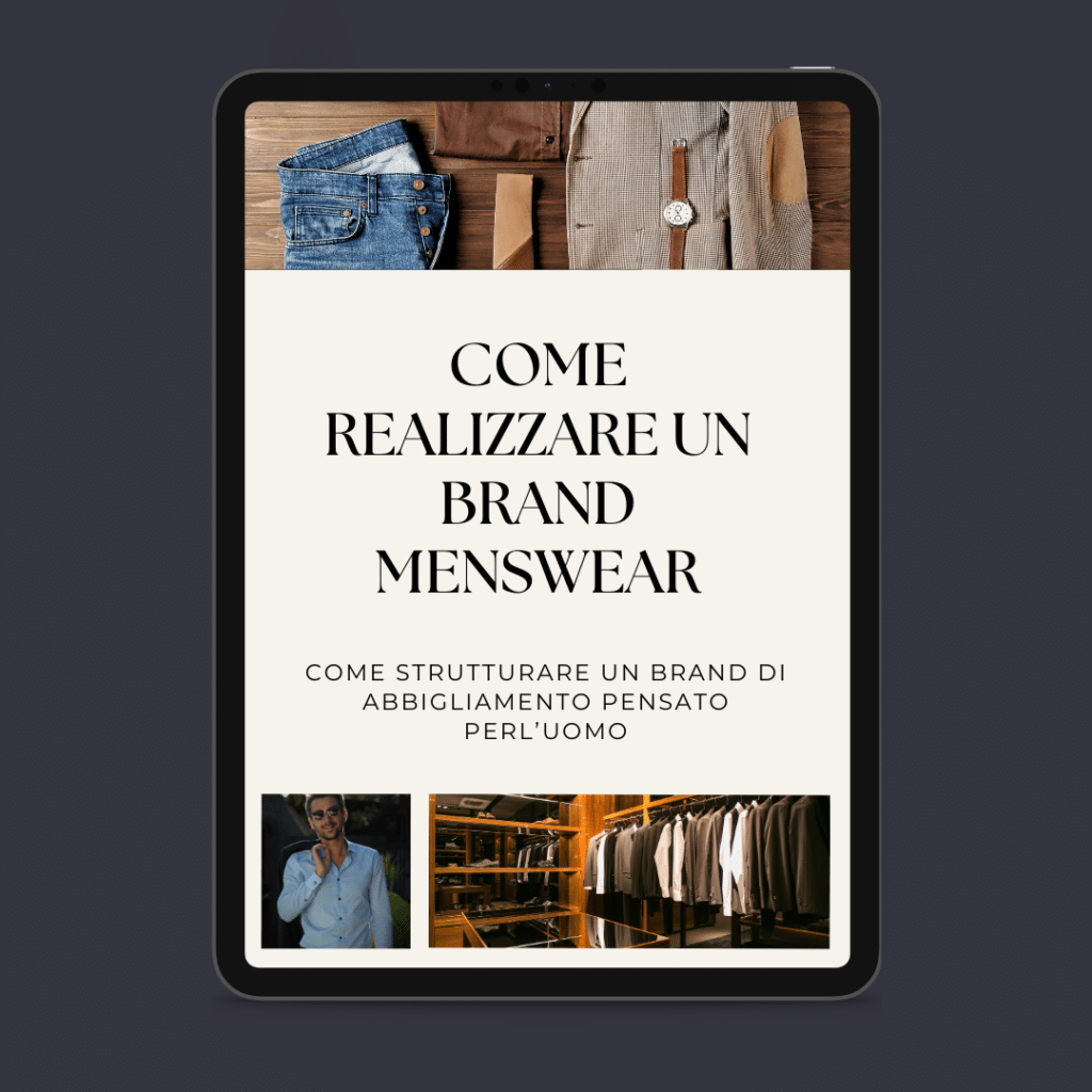 Un tablet che mostra una guida italiana intitolata "Come Realizzare un Brand Menswear" con immagini di vestiti, un uomo in giacca e cravatta e un guardaroba, sottolineando che battere la crisi è sempre questione di stile.