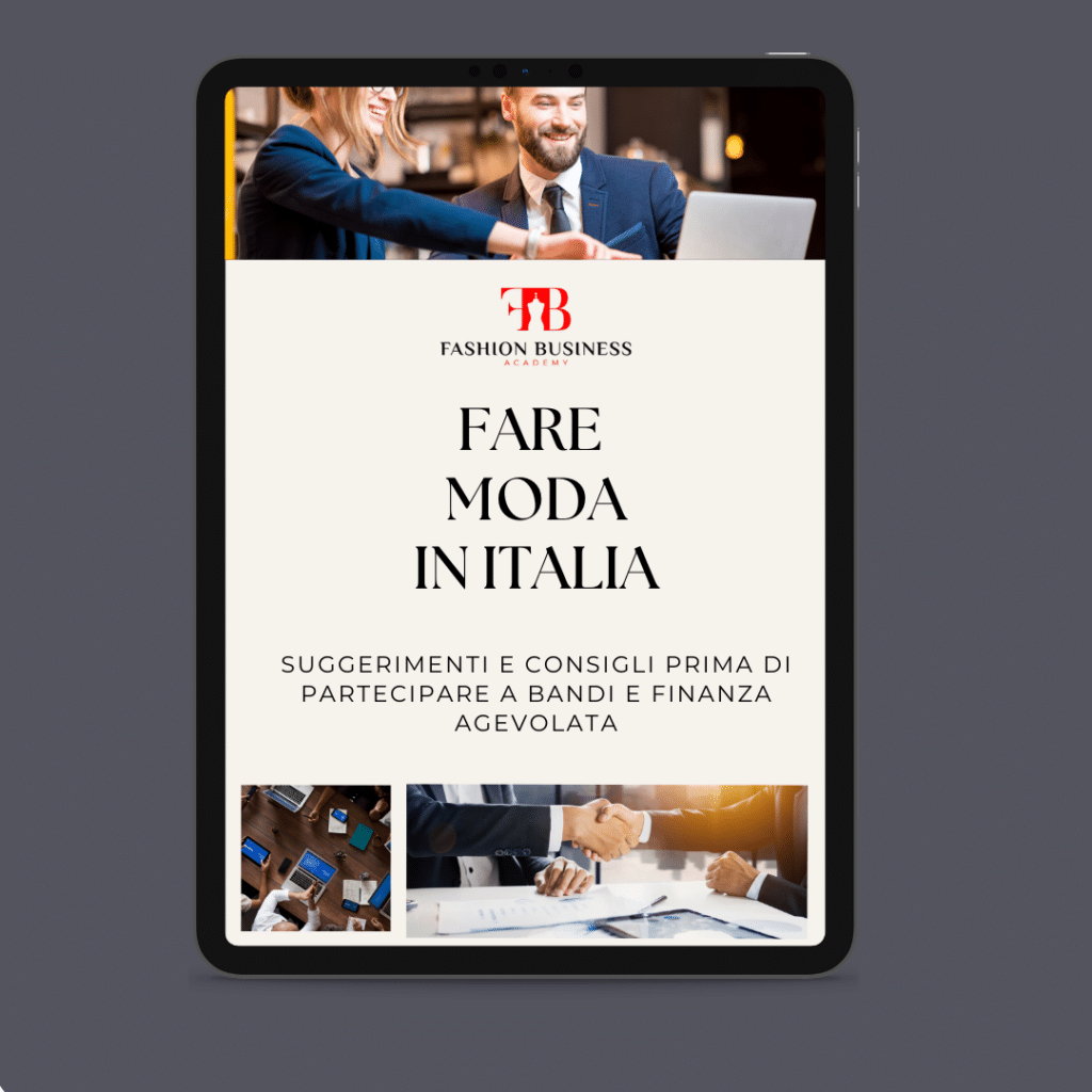 La copertina dell'e-book intitolata "Fare Moda in Italia" include uomini d'affari che si stringono la mano, il logo Fashion Business e un sottotesto sui consigli sulla partecipazione a finanziamenti e opportunità finanziarie nel settore della moda in Italia.